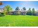 Lovely backyard featuring a spacious lawn and covered patio, ideal for relaxing and entertaining guests at 13133 Regulus Dr, Lone Tree, CO 80124