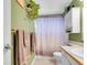 Bathroom with a shower and decorative towels, complemented by green walls and house plants at 13133 Regulus Dr, Lone Tree, CO 80124