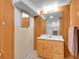 Rustic bathroom with wood paneling, mirror, sink, and shower stall at 13133 Regulus Dr, Lone Tree, CO 80124