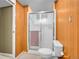 Well lit bathroom featuring a toilet and a shower with glass doors at 13133 Regulus Dr, Lone Tree, CO 80124