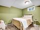Cozy bedroom with green walls, carpet flooring and a window for natural light at 13133 Regulus Dr, Lone Tree, CO 80124