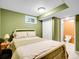 Modest bedroom featuring carpet floors, a window, and a door to the bathroom at 13133 Regulus Dr, Lone Tree, CO 80124
