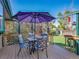Charming deck featuring a dining set, lush greenery, and partial shade from a patio umbrella at 13133 Regulus Dr, Lone Tree, CO 80124