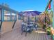 Outdoor deck with a dining set and partial shade from an umbrella at 13133 Regulus Dr, Lone Tree, CO 80124