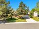 Charming home with a well-maintained front yard, mature trees, and an attached two-car garage at 13133 Regulus Dr, Lone Tree, CO 80124