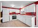 Bright kitchen with white cabinetry and ample counter space, and modern flooring at 13133 Regulus Dr, Lone Tree, CO 80124