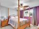 Bedroom with a four-poster bed, ceiling fan, and a bright window that lets in plenty of light at 13133 Regulus Dr, Lone Tree, CO 80124