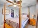 Bedroom with a four-poster bed, ceiling fan, and carpet flooring at 13133 Regulus Dr, Lone Tree, CO 80124