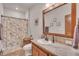 Bathroom with a wood-framed mirror, modern fixtures, and a shower featuring a decorative floral curtain at 6839 Estes Dr, Arvada, CO 80004