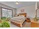 Cozy bedroom featuring a large window, wooden furniture, and comfortable bedding creating a warm and inviting space at 6839 Estes Dr, Arvada, CO 80004