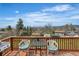Wood deck overlooking the landscape with furniture and room for seating at 6839 Estes Dr, Arvada, CO 80004