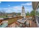View of a partially shaded wood deck with furniture overlooking the landscape at 6839 Estes Dr, Arvada, CO 80004