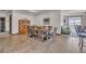 Dining room with large wooden table, plenty of seating, and access to living room and exterior deck at 6839 Estes Dr, Arvada, CO 80004