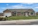 Charming brick home features a manicured lawn, a two-car garage, and lovely landscaping at 6839 Estes Dr, Arvada, CO 80004