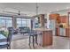 Open concept kitchen with stone fireplace, granite countertops, and barstool seating at 6839 Estes Dr, Arvada, CO 80004
