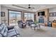 Cozy living room features a stone fireplace, plush seating, and sliding glass doors to the outside at 6839 Estes Dr, Arvada, CO 80004