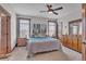 Serene main bedroom featuring two windows, ceiling fan, and a full dresser and mirror, creating a relaxing retreat at 6839 Estes Dr, Arvada, CO 80004