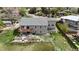 Aerial view of the home's rear exterior with a deck and landscaped yard at 6839 Estes Dr, Arvada, CO 80004