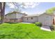 Wide shot of green backyard with patio at 3298 Quail St, Wheat Ridge, CO 80033