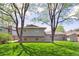 Large backyard with lush green lawn and mature trees at 3298 Quail St, Wheat Ridge, CO 80033