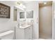 Bright bathroom with tiled shower, large vanity, and neutral color scheme at 3298 Quail St, Wheat Ridge, CO 80033