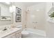 Cozy bathroom featuring a shower-tub combo, vanity with marble countertop, and decorative pendant lighting at 3298 Quail St, Wheat Ridge, CO 80033