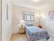Bright bedroom features a twin bed with a vibrant floral comforter and a colorful accent lamp at 3298 Quail St, Wheat Ridge, CO 80033