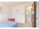 A view of the bedroom with a pink table and chairs, as well as closet space at 3298 Quail St, Wheat Ridge, CO 80033