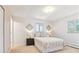 A bedroom with a large window, neutral decor, and a comfortable bed at 3298 Quail St, Wheat Ridge, CO 80033