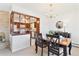 Dining room with dark wood table and chairs, chandelier lighting, and partial view of the kitchen at 3298 Quail St, Wheat Ridge, CO 80033