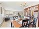 Open-concept dining area featuring a dark wood table set and views into living room and kitchen at 3298 Quail St, Wheat Ridge, CO 80033