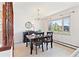 Bright dining area featuring a dark wood table set, large window, and decorative mirror at 3298 Quail St, Wheat Ridge, CO 80033