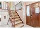 Inviting entryway featuring a staircase with wooden banister and a solid wood front door at 3298 Quail St, Wheat Ridge, CO 80033