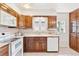 A kitchen featuring wooden cabinets, white countertops, and a white dishwasher at 3298 Quail St, Wheat Ridge, CO 80033