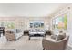 Bright living room with large windows, neutral paint, and comfortable seating arrangements at 3298 Quail St, Wheat Ridge, CO 80033