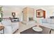 Inviting living room with a brick fireplace, comfortable seating, and a view into the dining area at 3298 Quail St, Wheat Ridge, CO 80033