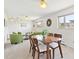 Open-concept dining and living area with natural light and a neutral color palette at 3298 Quail St, Wheat Ridge, CO 80033