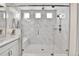 Gorgeous glass enclosed shower with marble tile, rain shower head and handheld shower fixture at 1195 Melting Snow Way, Castle Rock, CO 80109