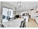 Open-concept dining area flowing to the kitchen and patio, perfect for entertaining and modern living at 1195 Melting Snow Way, Castle Rock, CO 80109