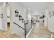 Inviting entryway with light wood floors and modern railing leading to a spacious living area at 1195 Melting Snow Way, Castle Rock, CO 80109