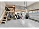 Garage with a loft area, epoxy floor, and ample storage for tools and equipment at 1195 Melting Snow Way, Castle Rock, CO 80109