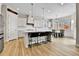 Well-appointed kitchen with island seating, modern light fixtures, and an adjacent dining area at 1195 Melting Snow Way, Castle Rock, CO 80109