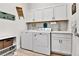 Functional laundry room equipped with a washer, dryer, sink, and storage cabinets for easy organization at 1195 Melting Snow Way, Castle Rock, CO 80109