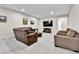 Spacious living room featuring a leather sofa, TV, and recessed lighting, perfect for relaxing and entertaining guests at 1195 Melting Snow Way, Castle Rock, CO 80109