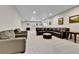 Large living room with leather couches, recessed lighting, and neutral carpet, creating a versatile and comfortable space at 1195 Melting Snow Way, Castle Rock, CO 80109
