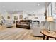 Spacious living area with wood floors, comfortable seating, and an open layout to the kitchen at 1195 Melting Snow Way, Castle Rock, CO 80109