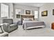 Comfortable main bedroom featuring neutral paint, gray carpet, side table, and sitting chair at 1195 Melting Snow Way, Castle Rock, CO 80109