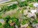 An aerial view showing a large lot with mature trees, neighboring homes, and proximity to the highway at 1961 S Xenia Ct, Denver, CO 80231
