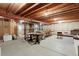 Unfinished basement with exposed ceiling, cement walls, and floor offers potential for customization at 1961 S Xenia Ct, Denver, CO 80231