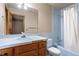 Bathroom featuring a vanity, toilet, and bathtub with blue tiles and a white shower curtain at 1961 S Xenia Ct, Denver, CO 80231